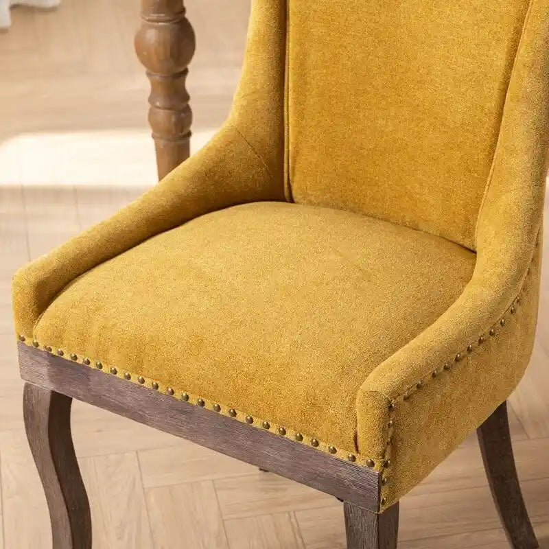 Sedie da pranzo in tessuto imbottito con gambe in legno massello e borchie in bronzo, set da 2